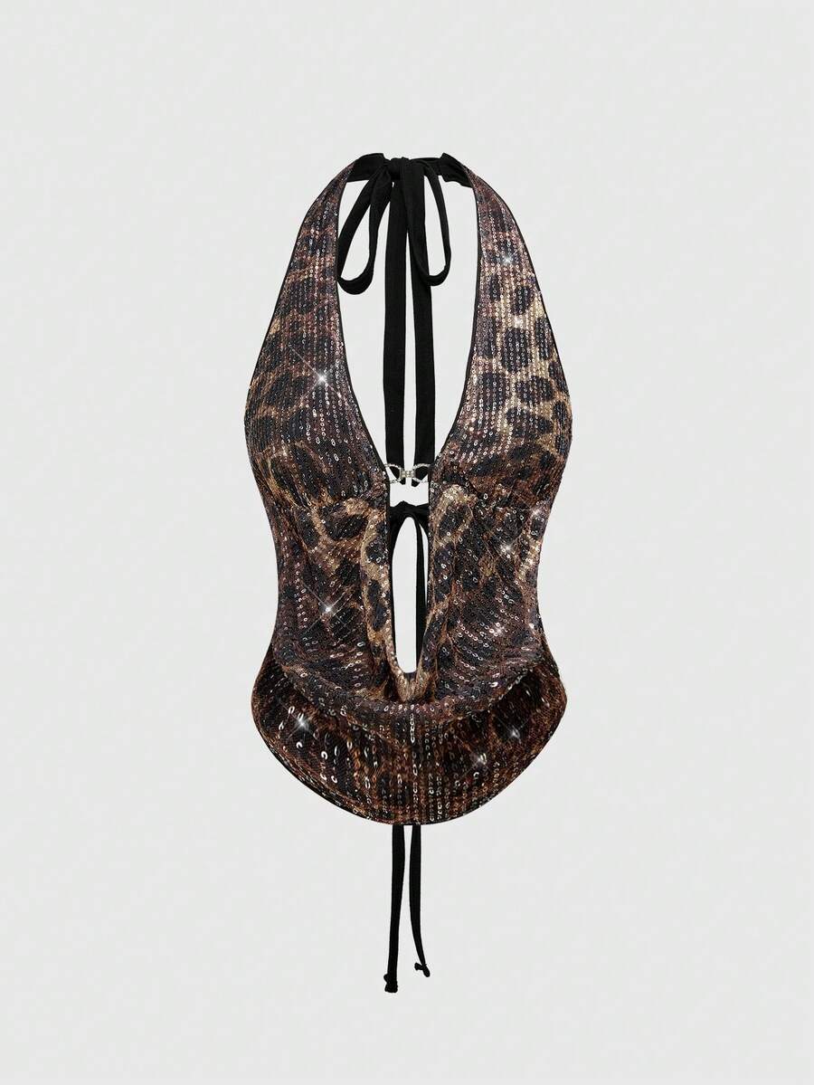 Women's leopard print sequin halter crop top featuring a backless asymmetrical hem design with ring accent.