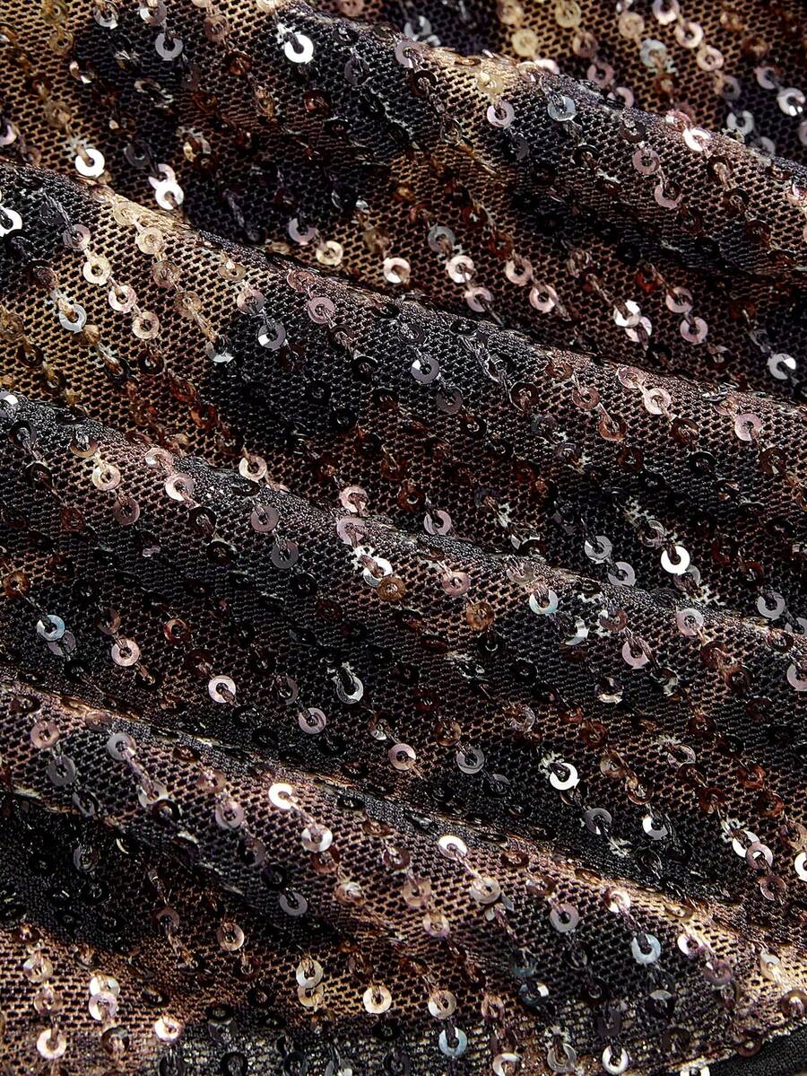 Women's leopard print sequin halter crop top featuring a backless asymmetrical hem design with ring accent.