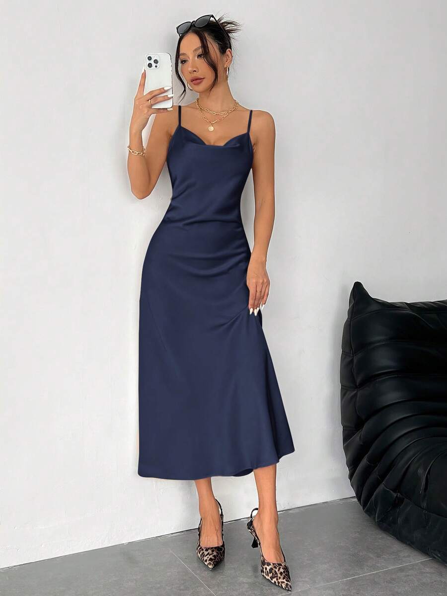 Women's long apricot satin cami dress featuring a draped swing collar, spaghetti straps, backless zipper back, and mermaid hem.