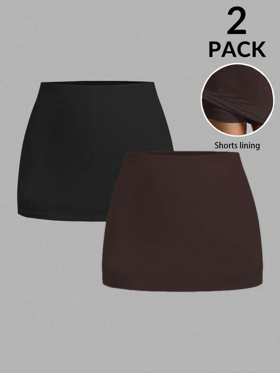 Women's black casual low rise bodycon mini skort with built-in shorts in knitted plain stretch fabric.