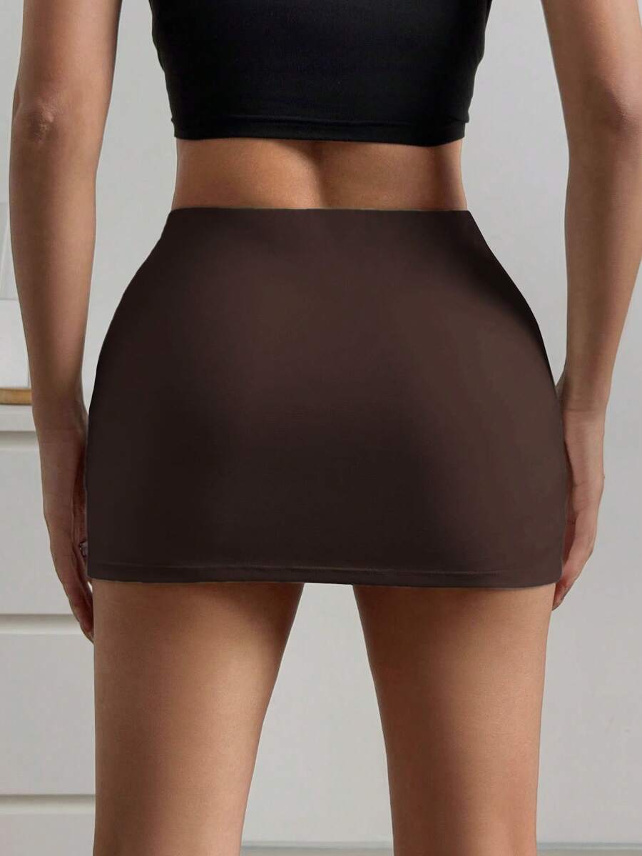 Women's black casual low rise bodycon mini skort with built-in shorts in knitted plain stretch fabric.