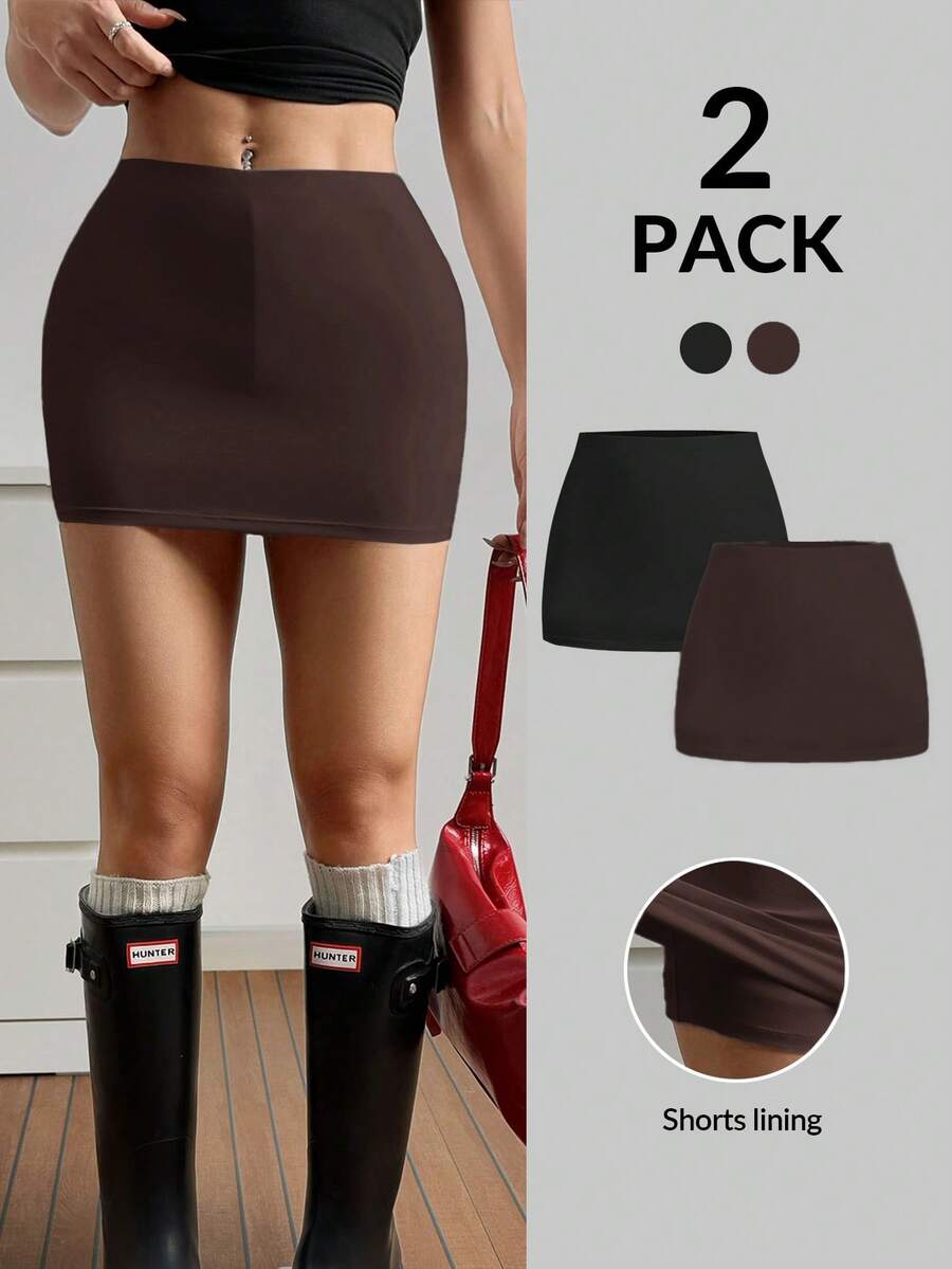 Women's black casual low rise bodycon mini skort with built-in shorts in knitted plain stretch fabric.