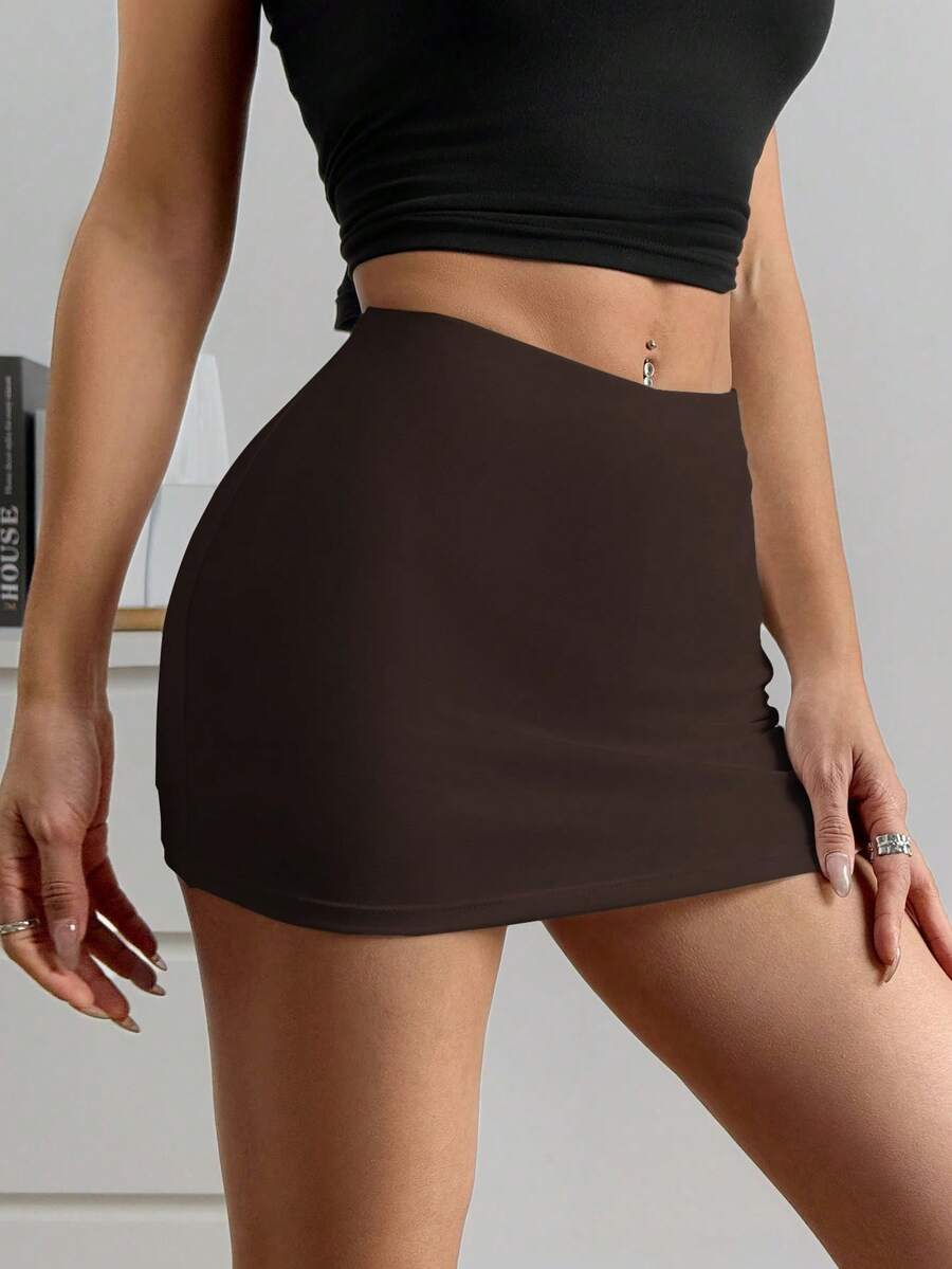 Women's black casual low rise bodycon mini skort with built-in shorts in knitted plain stretch fabric.