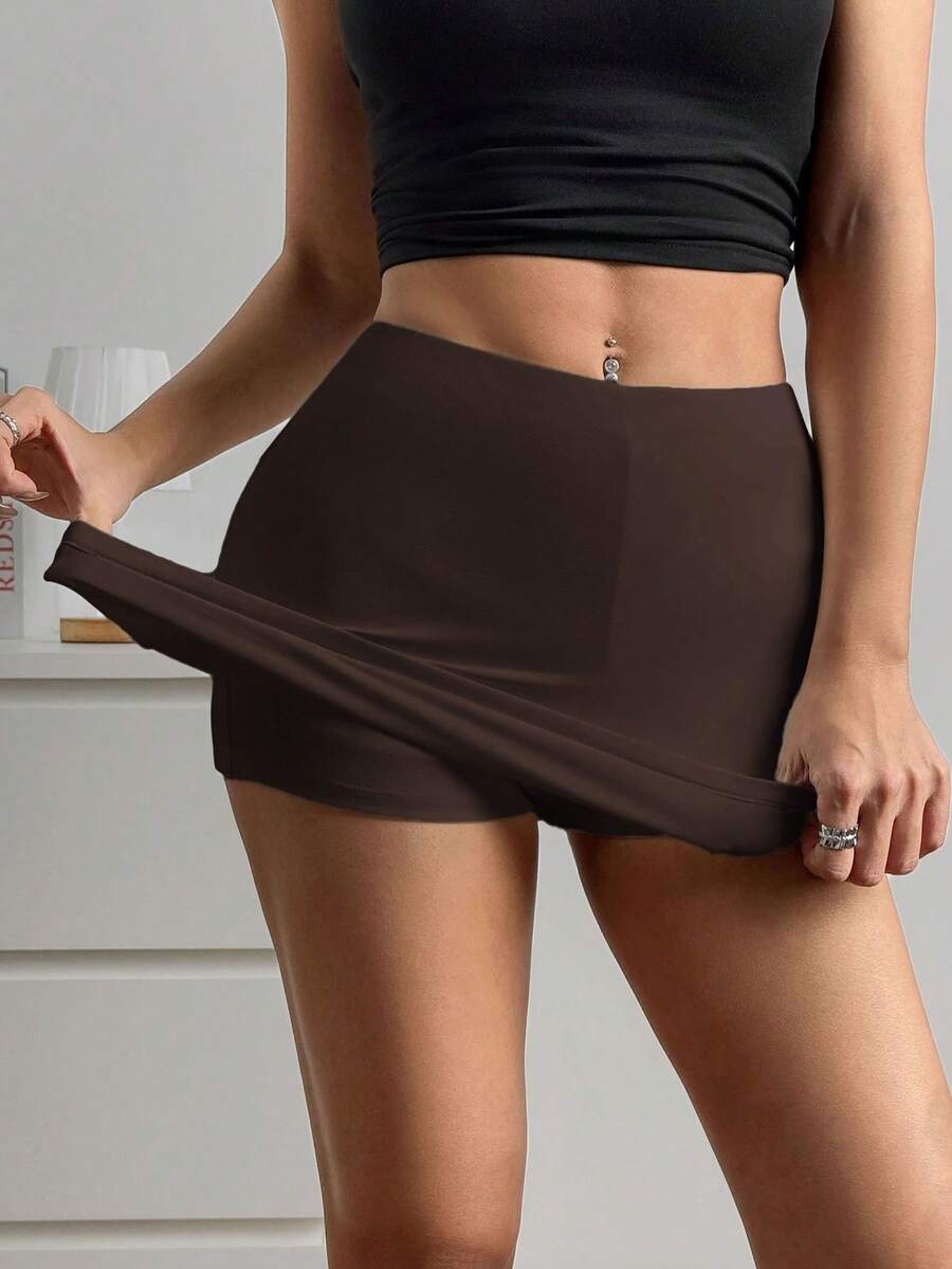 Women's black casual low rise bodycon mini skort with built-in shorts in knitted plain stretch fabric.