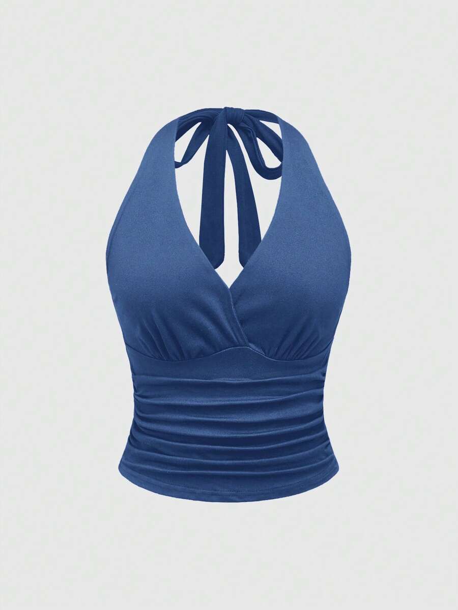 Women's halter crop tank top featuring a backless silhouette and ruched detailing in a slim fit design.
