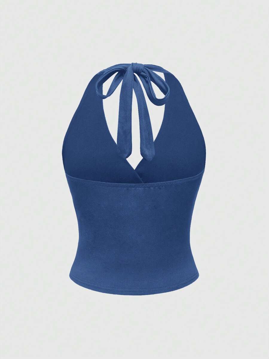 Women's halter crop tank top featuring a backless silhouette and ruched detailing in a slim fit design.