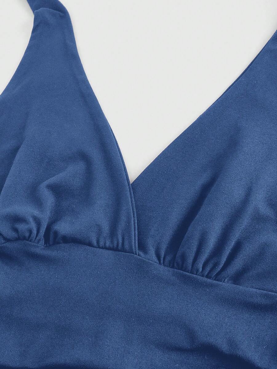 Women's halter crop tank top featuring a backless silhouette and ruched detailing in a slim fit design.
