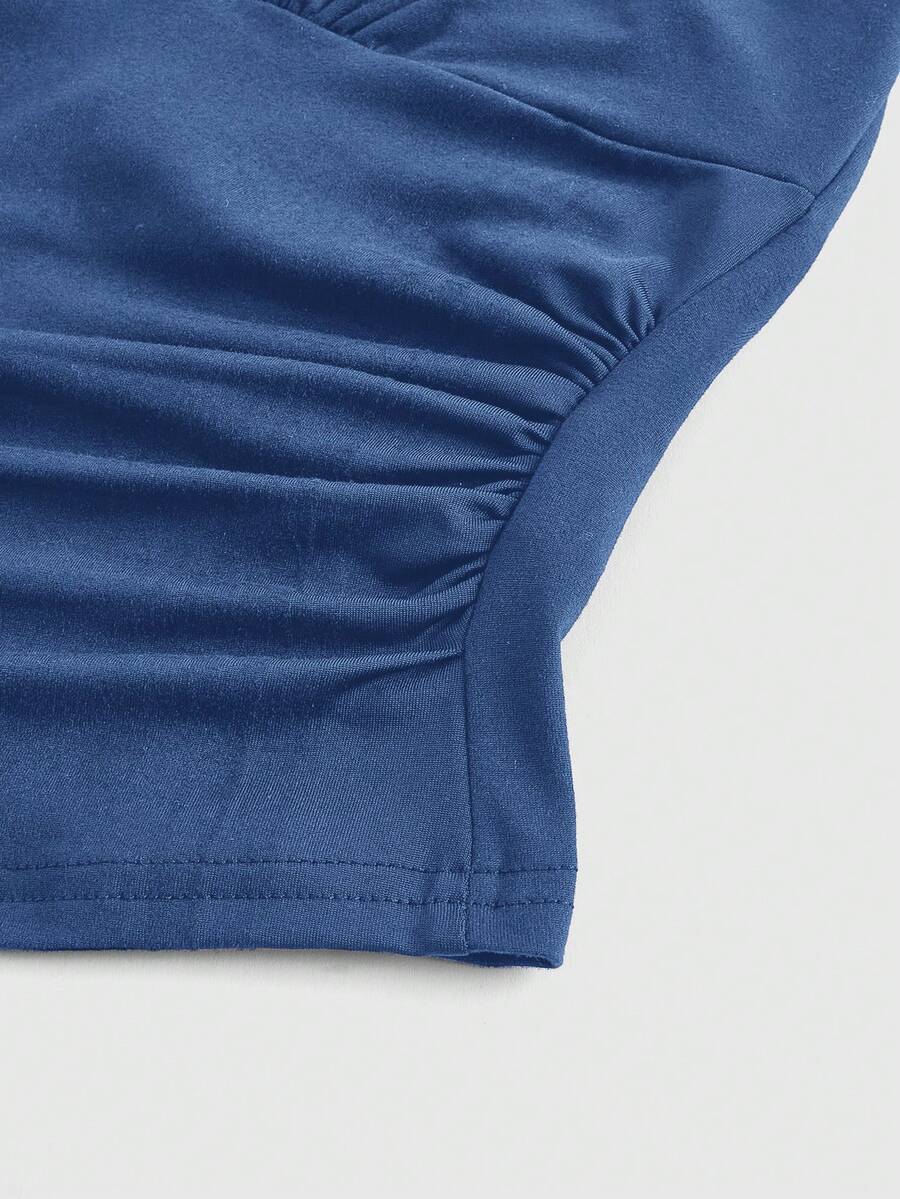 Women's halter crop tank top featuring a backless silhouette and ruched detailing in a slim fit design.