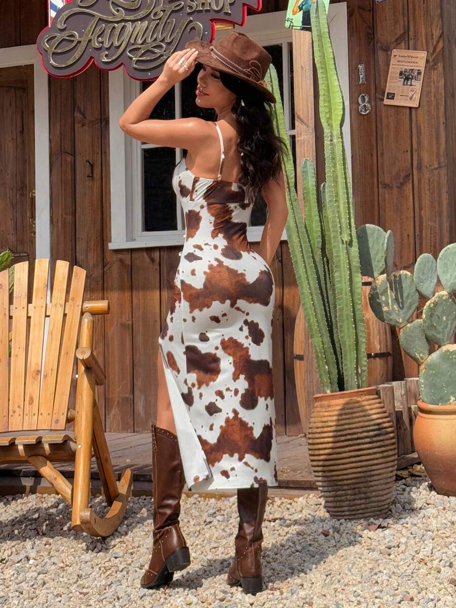 Black and white cow print cami midi dress for women featuring spaghetti straps, ruched bust, backless detail, and a split thigh hem.