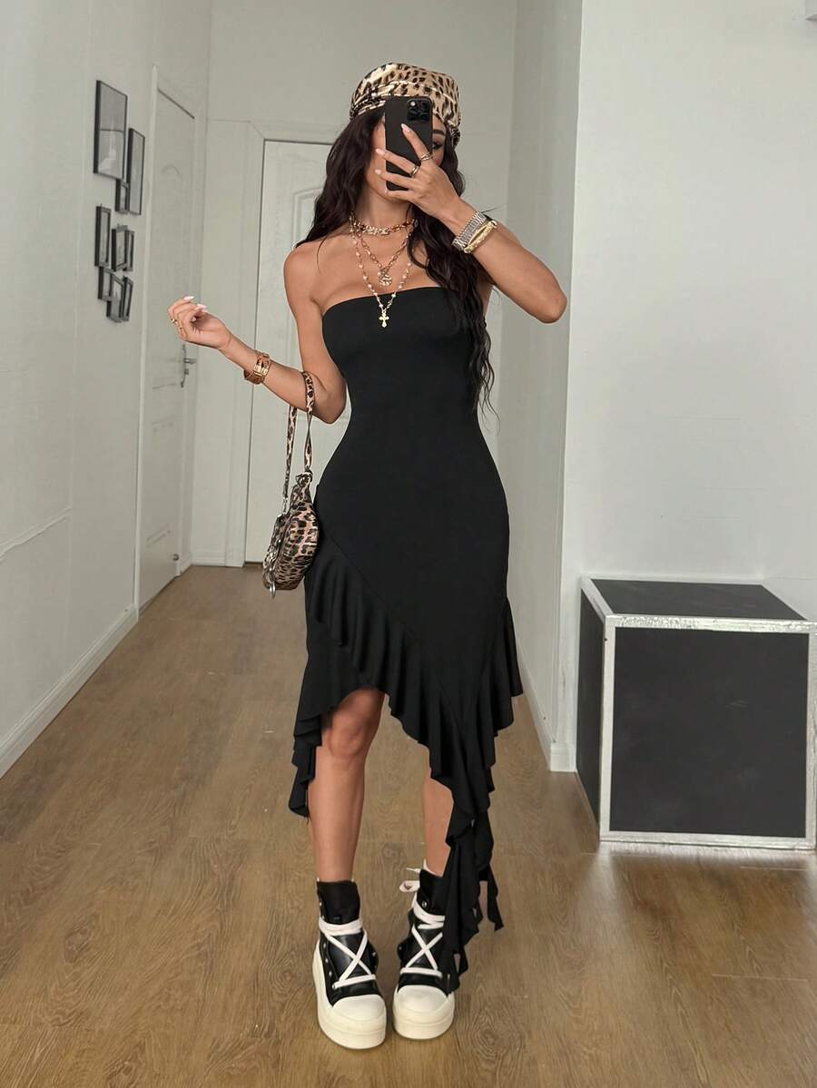 Women's strapless black bandeau midi dress featuring an asymmetrical ruffle hem and a slim fit bodycon silhouette.