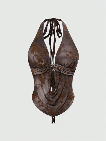 Brown tie dye halter crop top for women featuring a backless design, asymmetrical hem with ring detail, and flocked floral print.
