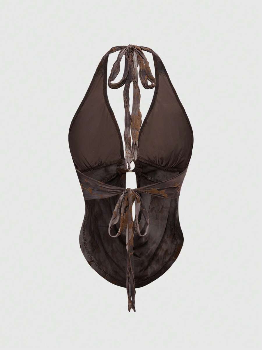 Brown tie dye halter crop top for women featuring a backless design, asymmetrical hem with ring detail, and flocked floral print.