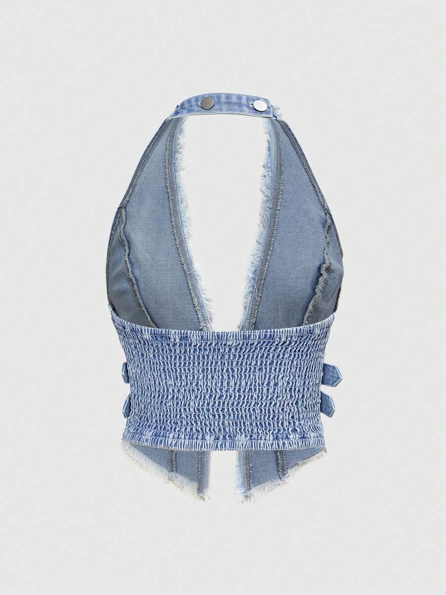 Women's denim halter crop top featuring a backless design, asymmetrical hem, single-breasted front, and lettuce trim.