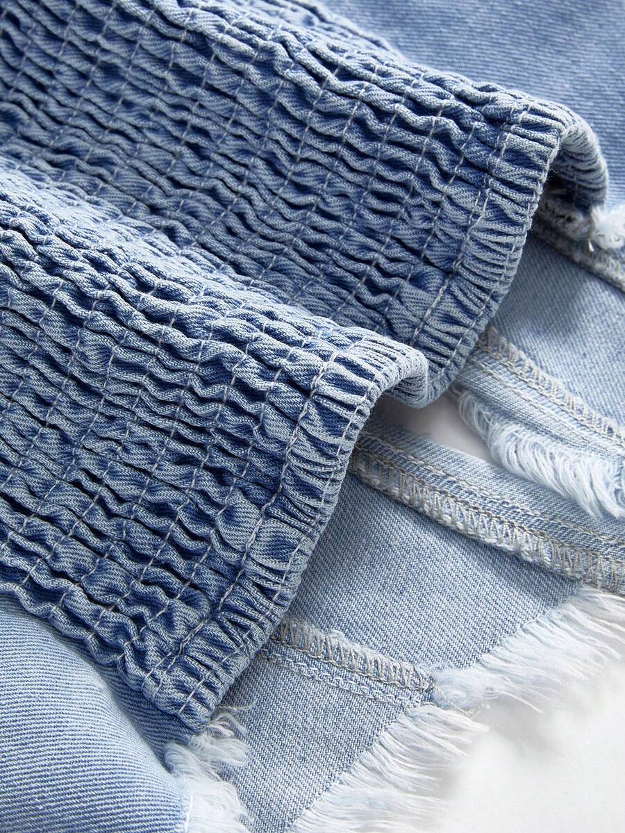 Women's denim halter crop top featuring a backless design, asymmetrical hem, single-breasted front, and lettuce trim.