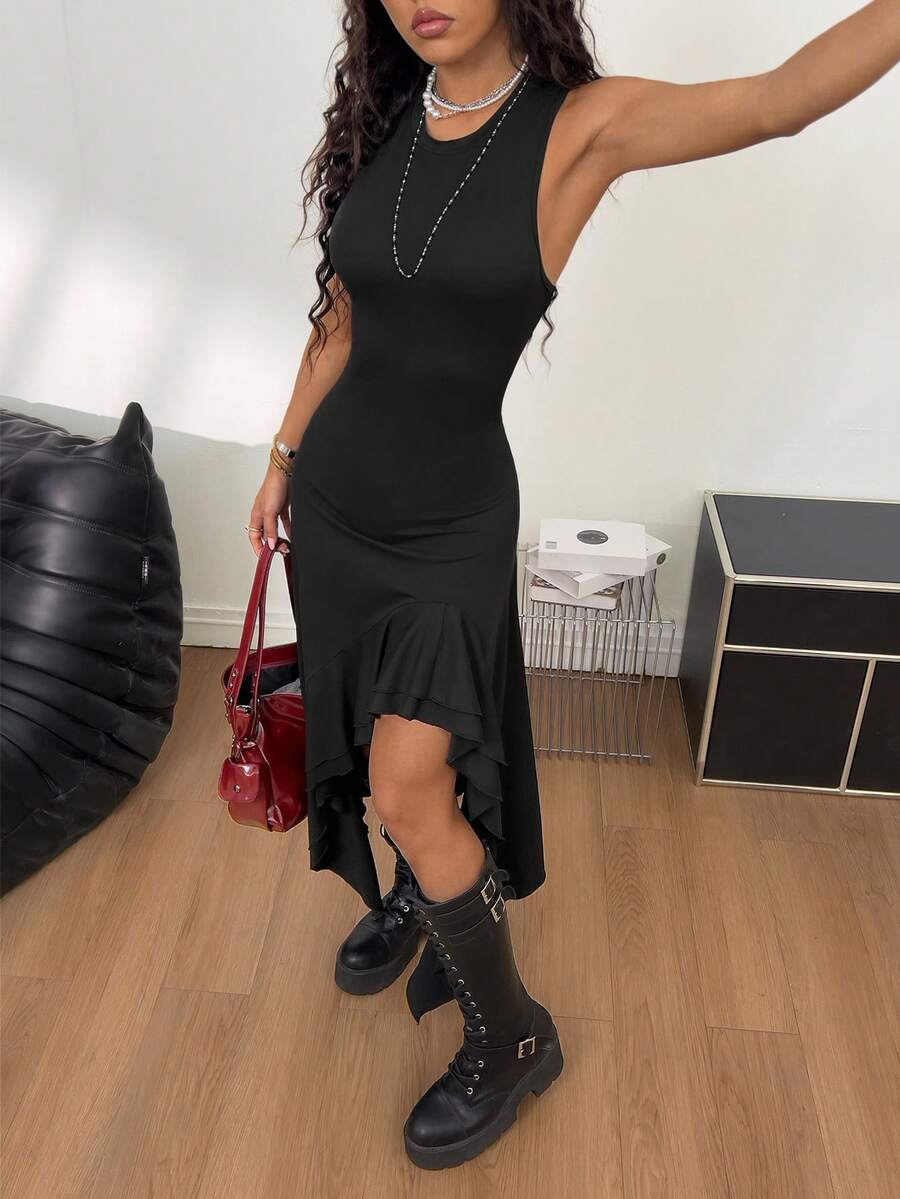 Women wearing a sleeveless army green long dress with a round neck and asymmetrical ruffle hem.