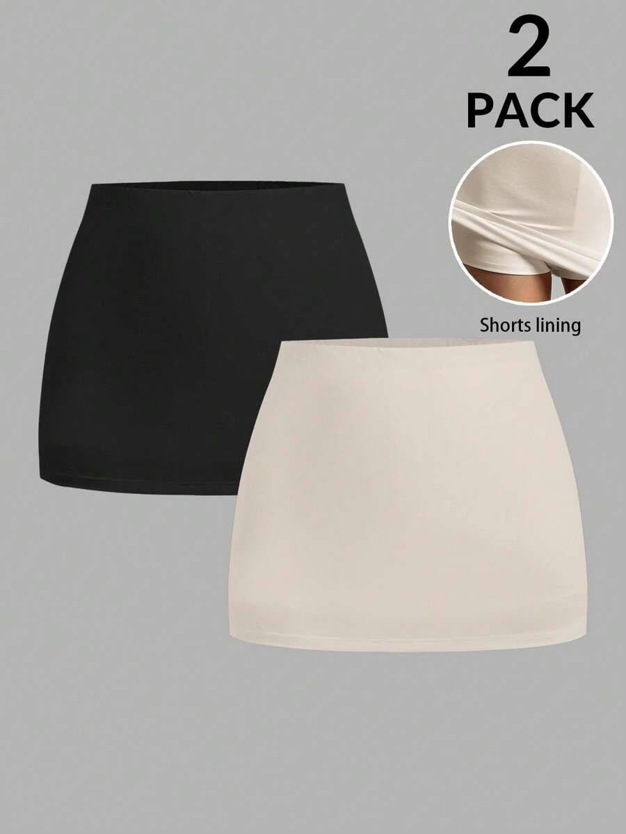 Women's black casual low rise bodycon mini skort with built-in shorts in knitted plain stretch fabric.