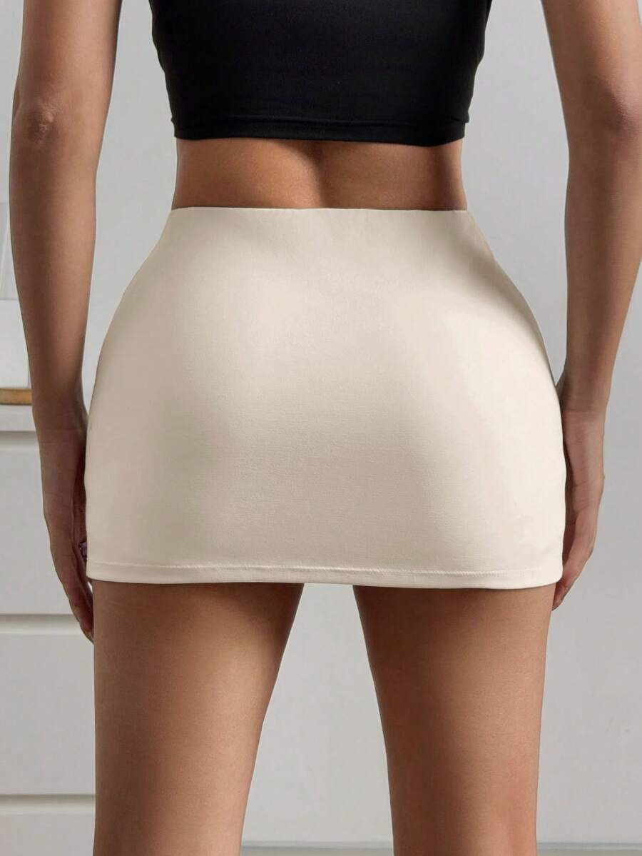 Women's black casual low rise bodycon mini skort with built-in shorts in knitted plain stretch fabric.