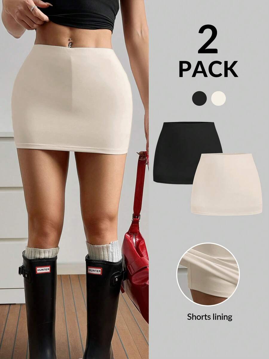 Women's black casual low rise bodycon mini skort with built-in shorts in knitted plain stretch fabric.