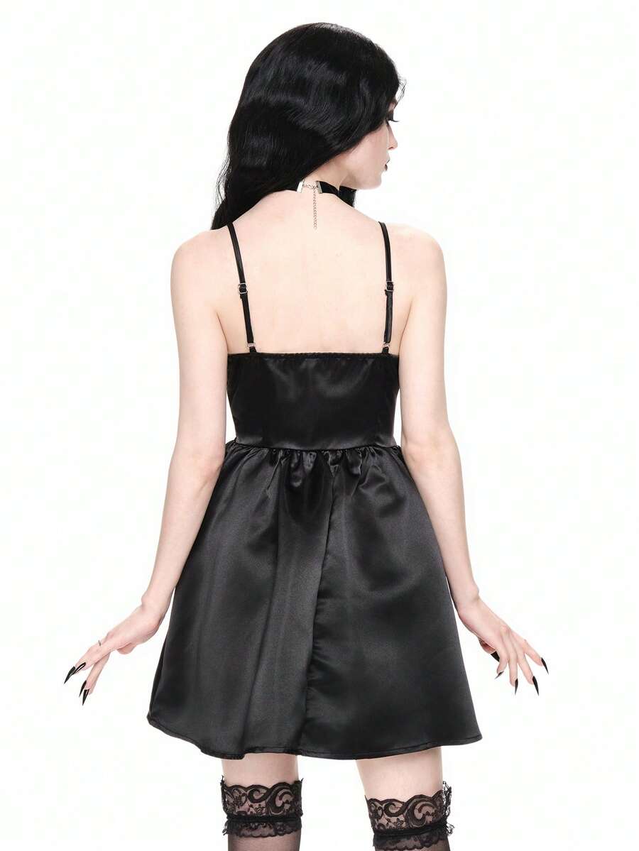 Front view of women wearing black gothic satin mini dress with contrast lace trim, bow accent, spaghetti straps, high waist, and tiered flared hem.