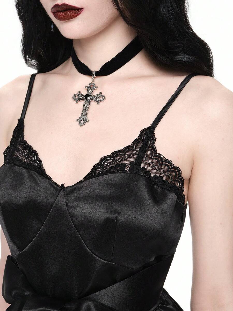 Front view of women wearing black gothic satin mini dress with contrast lace trim, bow accent, spaghetti straps, high waist, and tiered flared hem.