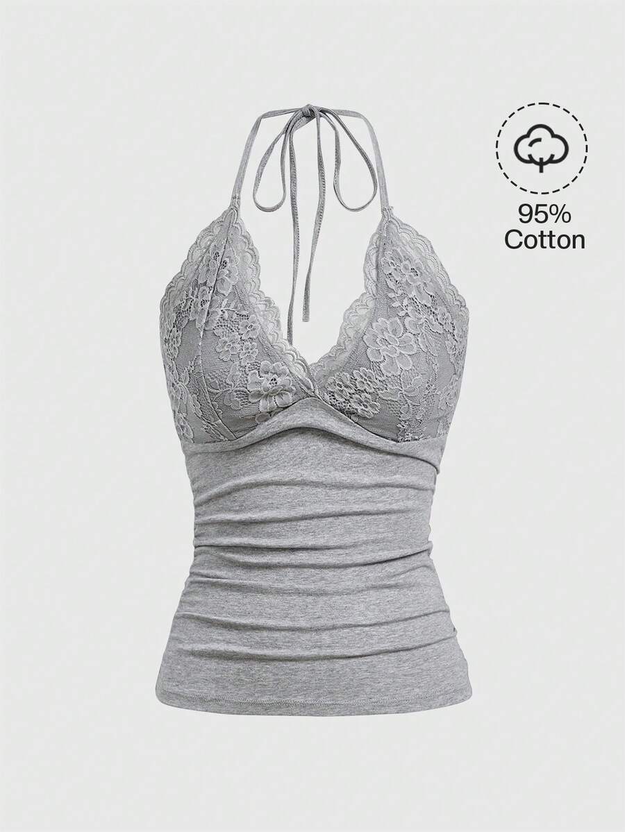 A women's black backless halter top featuring contrast lace trim, ruched front detail, and slim fit soft knitted fabric.
