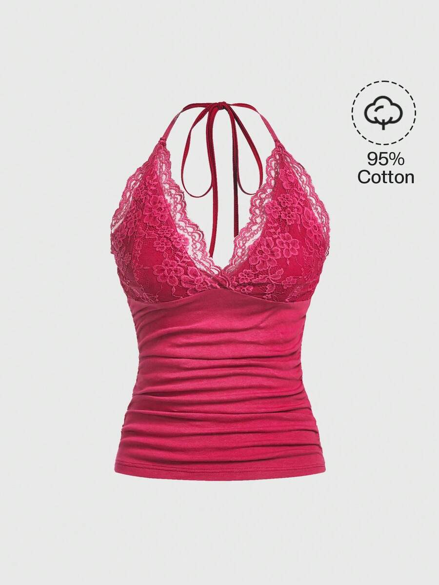 A women's black backless halter top featuring contrast lace trim, ruched front detail, and slim fit soft knitted fabric.