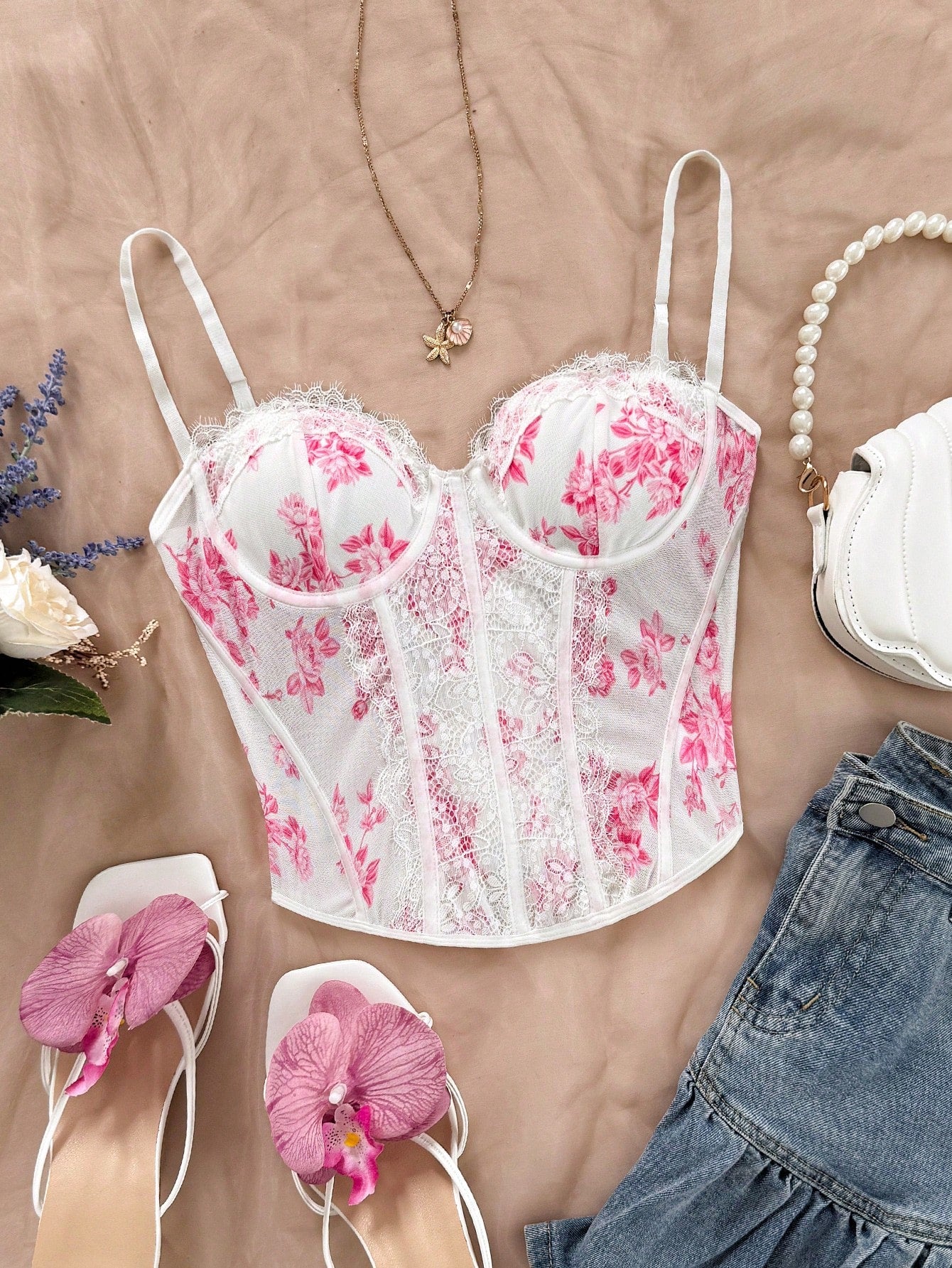 Women's lace bustier camisole top with spaghetti straps, contrast lace, lace-up detail, and an asymmetrical hem in a slim fit design.