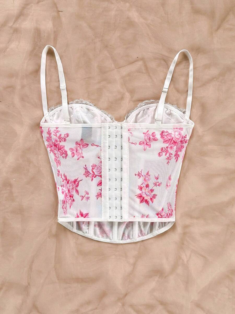 Women's lace bustier camisole top with spaghetti straps, contrast lace, lace-up detail, and an asymmetrical hem in a slim fit design.