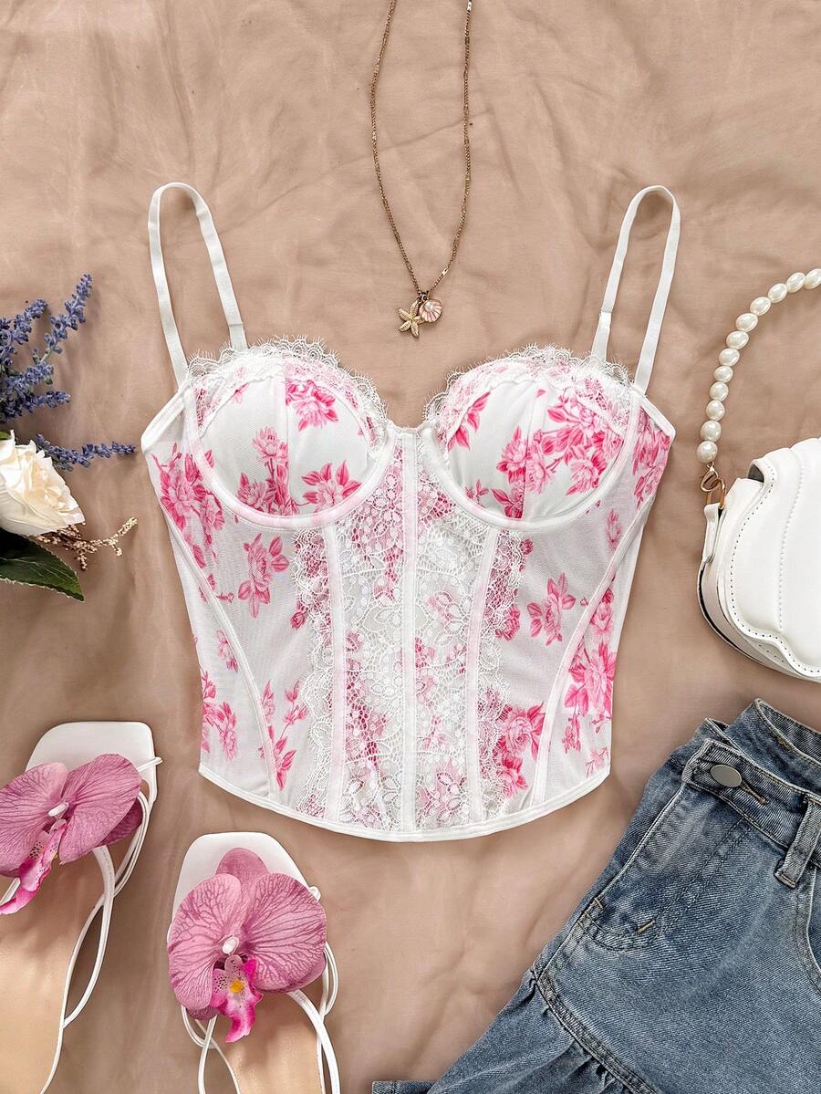 Women's lace bustier camisole top with spaghetti straps, contrast lace, lace-up detail, and an asymmetrical hem in a slim fit design.