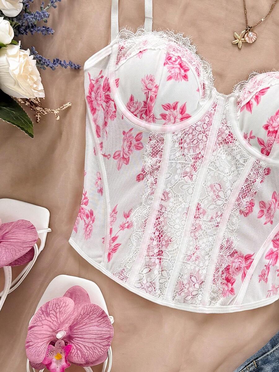 Women's lace bustier camisole top with spaghetti straps, contrast lace, lace-up detail, and an asymmetrical hem in a slim fit design.