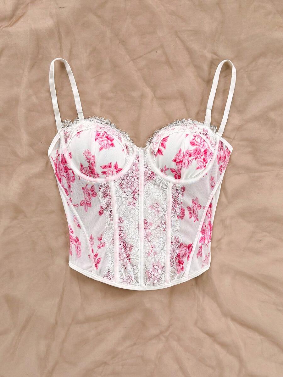 Women's lace bustier camisole top with spaghetti straps, contrast lace, lace-up detail, and an asymmetrical hem in a slim fit design.