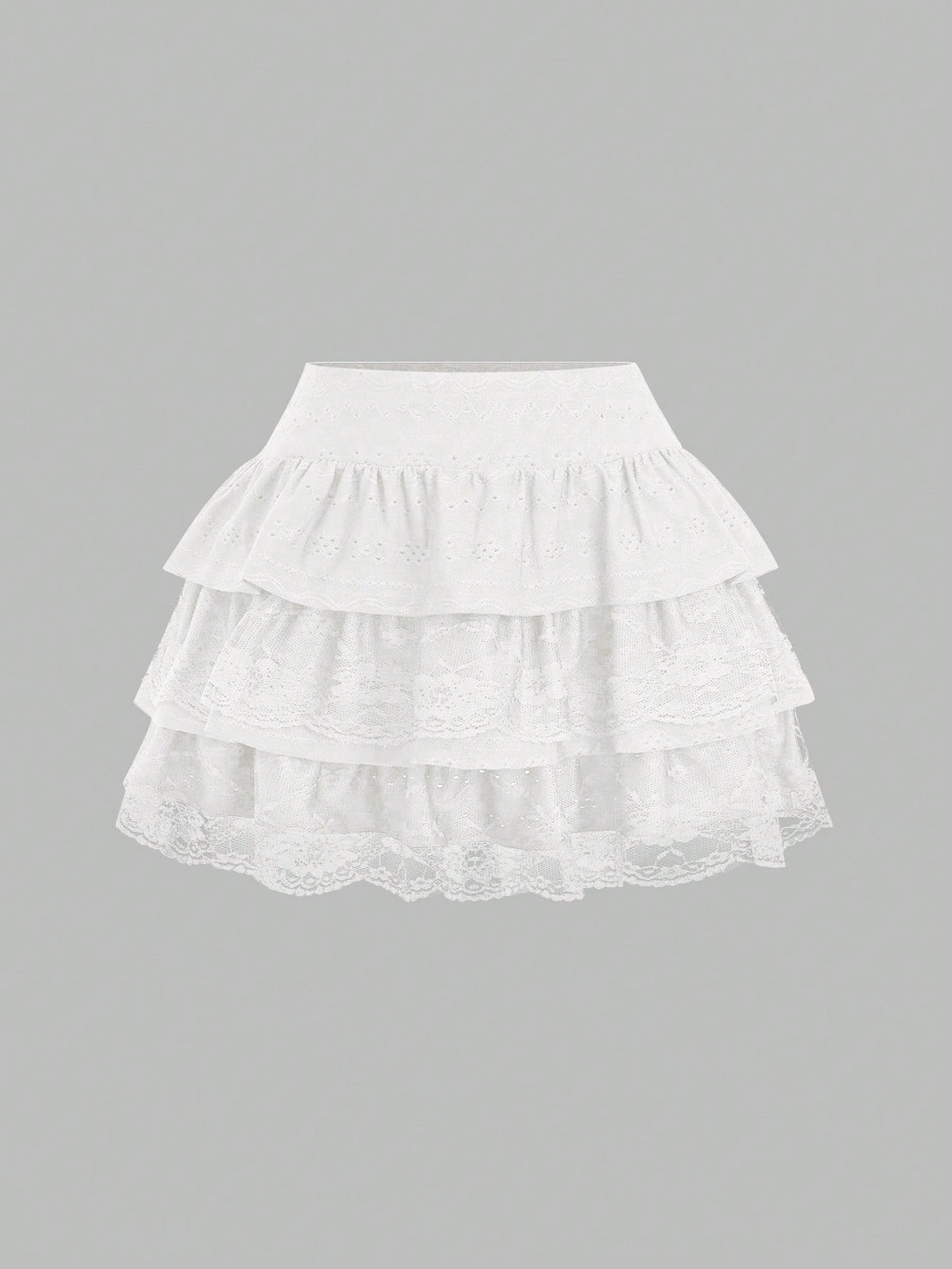 White Y2K layered ruffle mini skirt with contrast lace trim, low waist, and tiered hem.