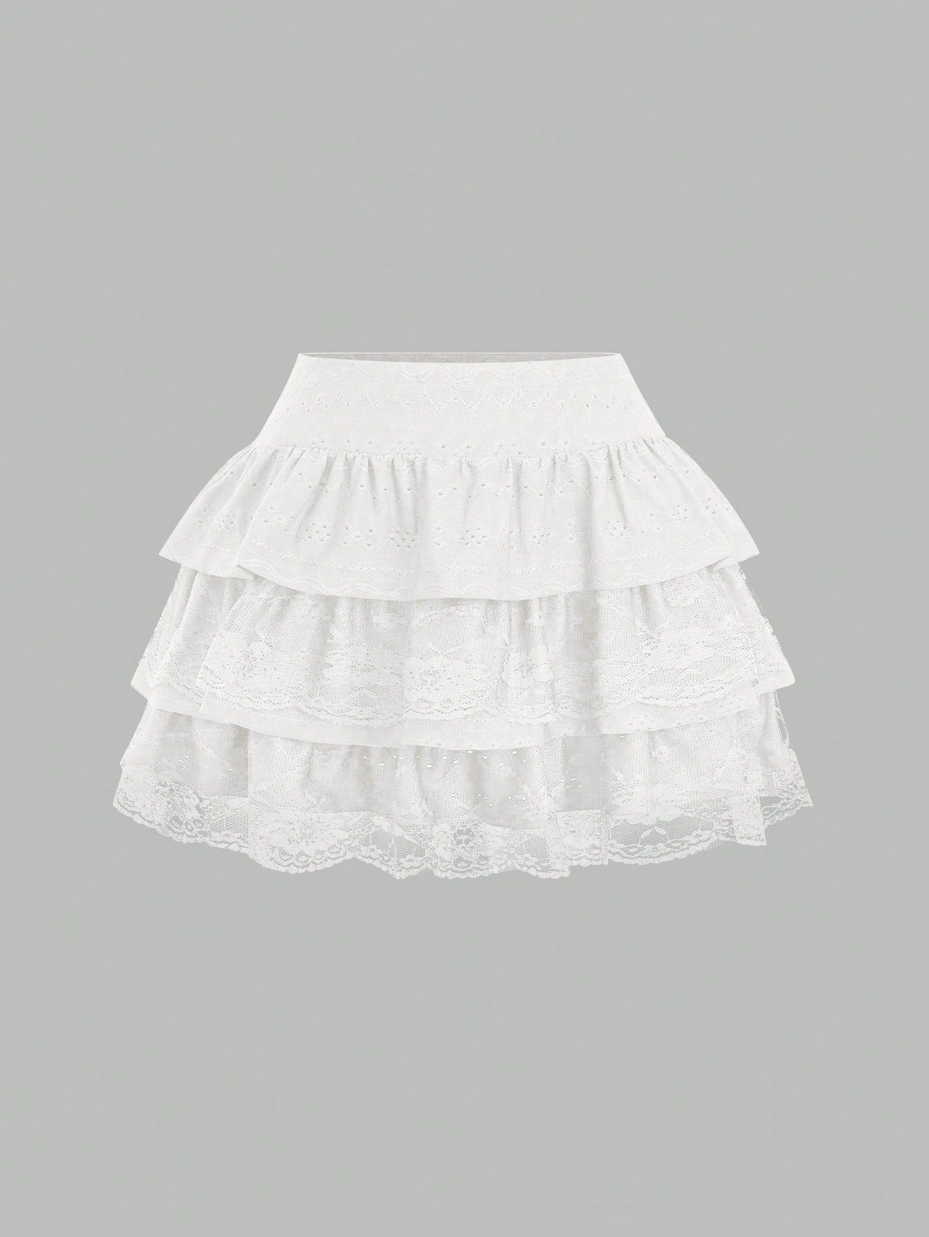 White Y2K layered ruffle mini skirt with contrast lace trim, low waist, and tiered hem.