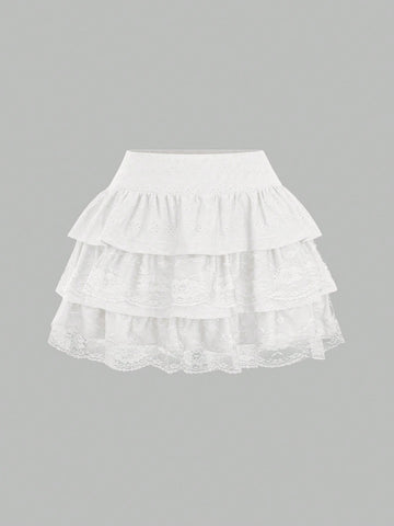 White Y2K layered ruffle mini skirt with contrast lace trim, low waist, and tiered hem.