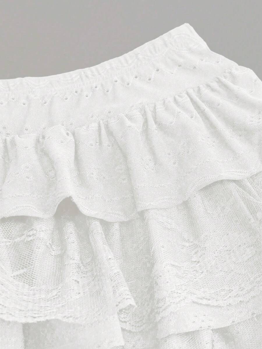 White Y2K layered ruffle mini skirt with contrast lace trim, low waist, and tiered hem.