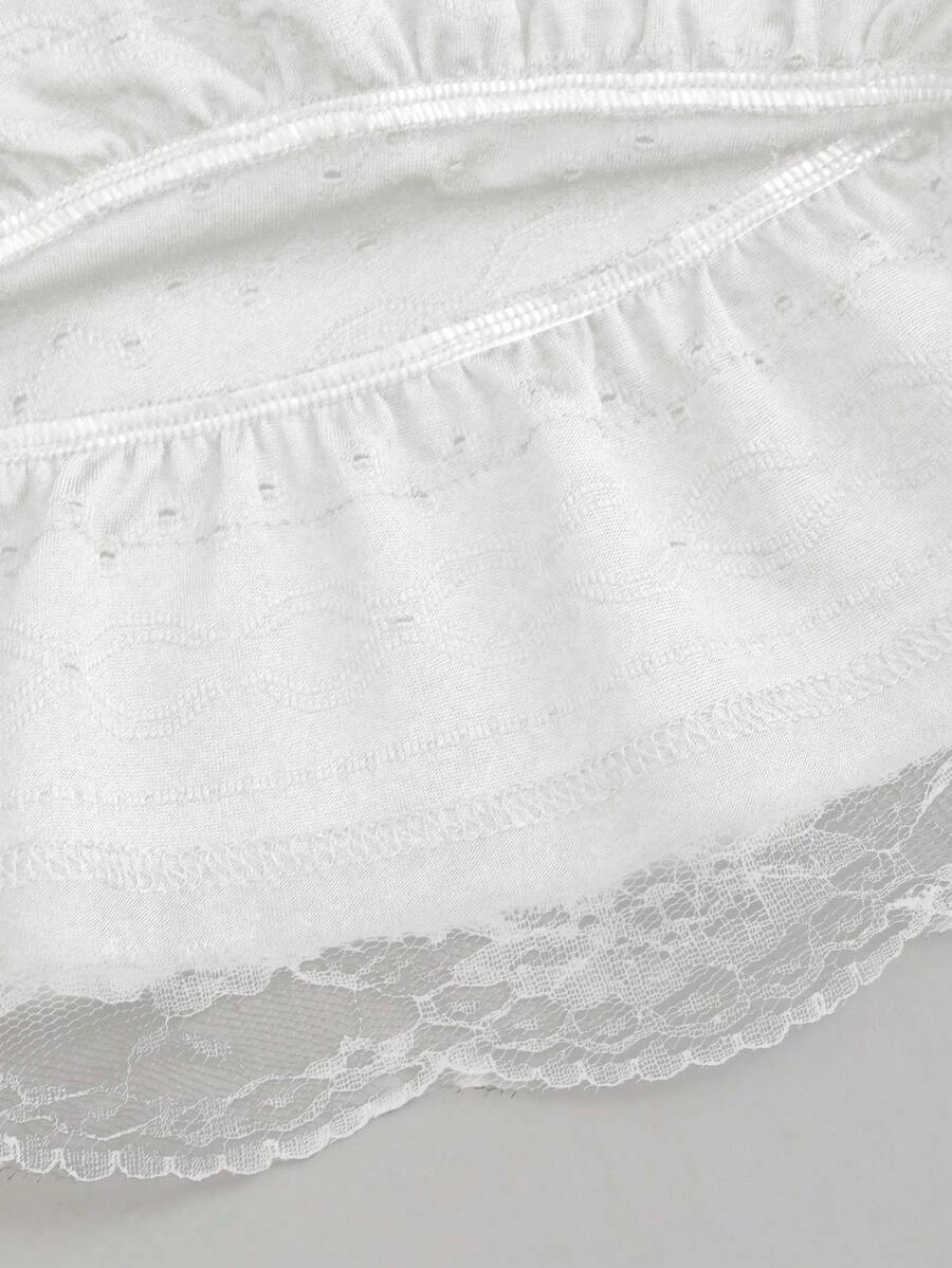 White Y2K layered ruffle mini skirt with contrast lace trim, low waist, and tiered hem.