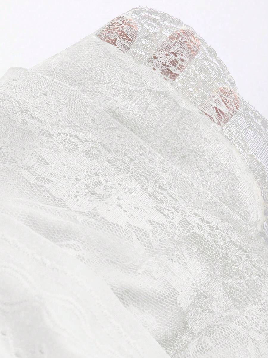 White Y2K layered ruffle mini skirt with contrast lace trim, low waist, and tiered hem.
