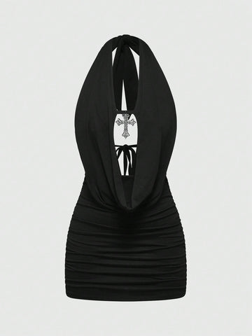 Black halter bodycon mini dress for women featuring a backless cut-out design, ruched detail, and a rhinestone cross pendant.