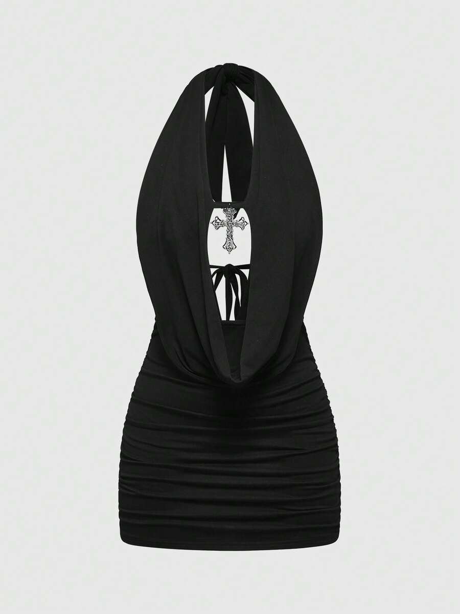 Black halter bodycon mini dress for women featuring a backless cut-out design, ruched detail, and a rhinestone cross pendant.