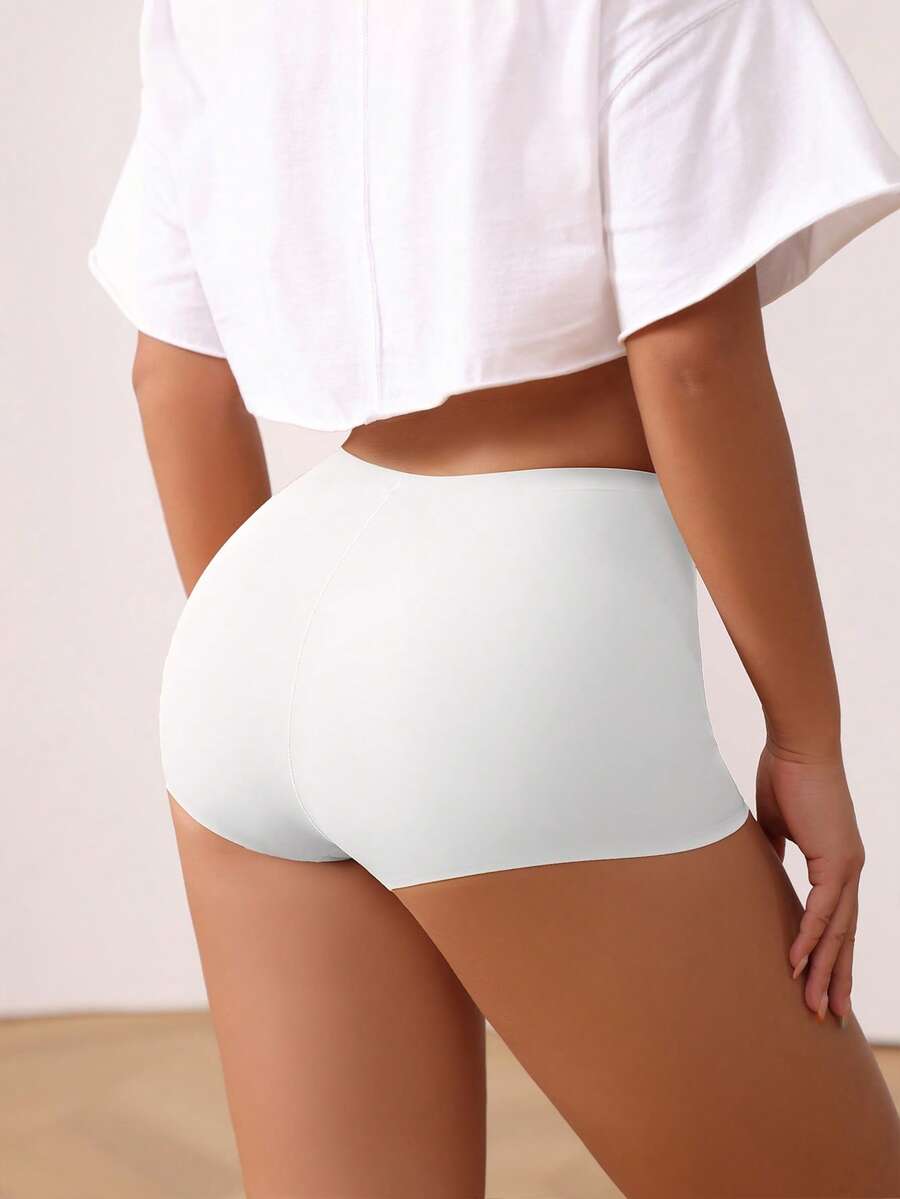 Women's black high stretch shapewear shorts with a mid waist fit and semi-sheer fabric.