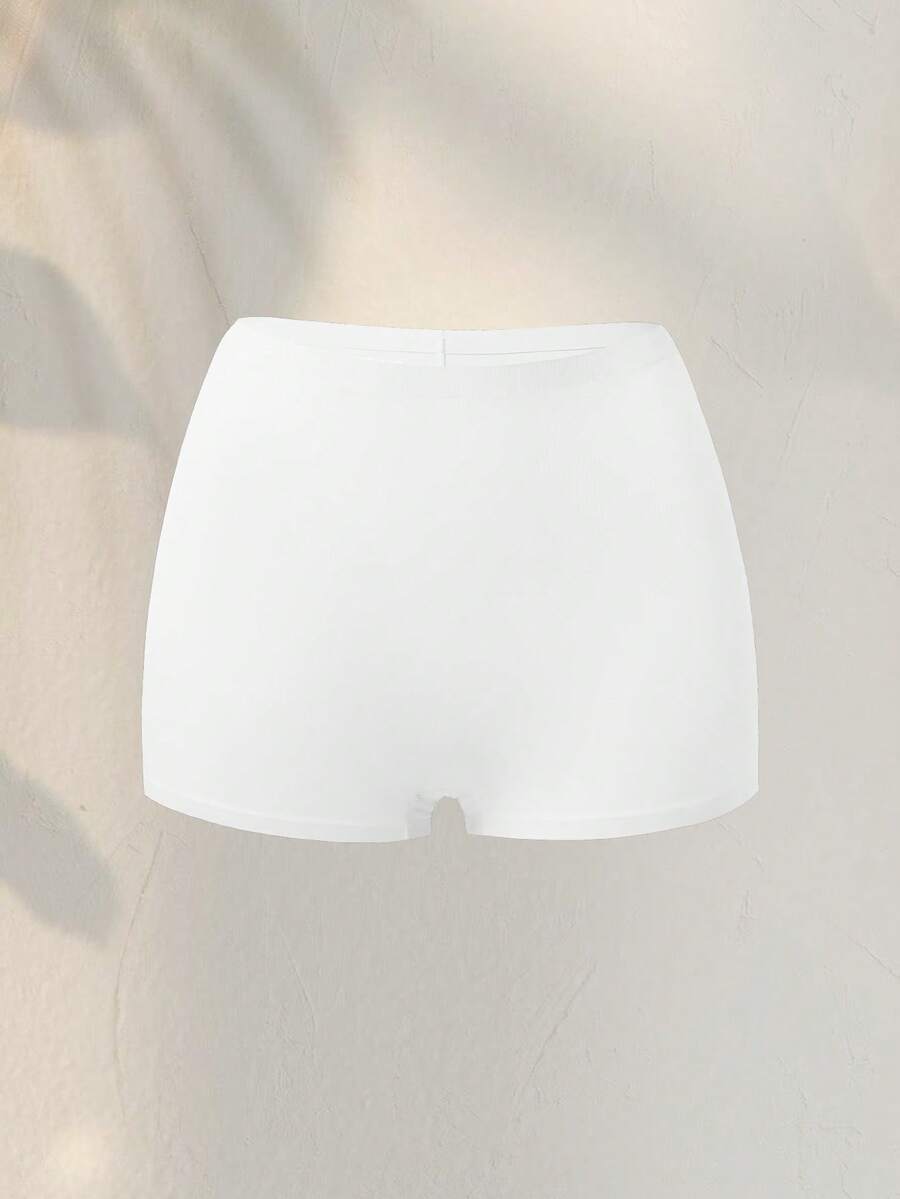 Women's black high stretch shapewear shorts with a mid waist fit and semi-sheer fabric.