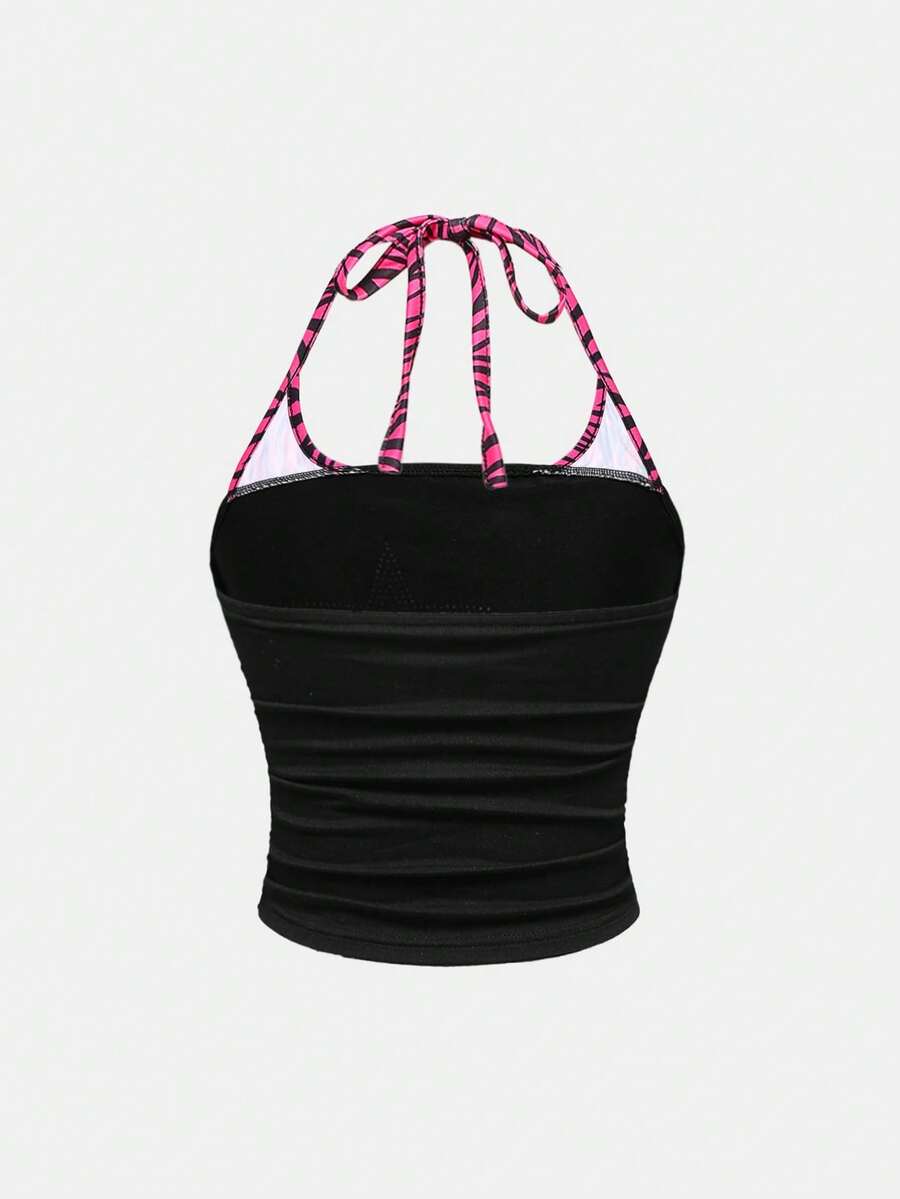 Black Y2K halter crop camisole top featuring a backless design, ruched detailing, and appliques for women.