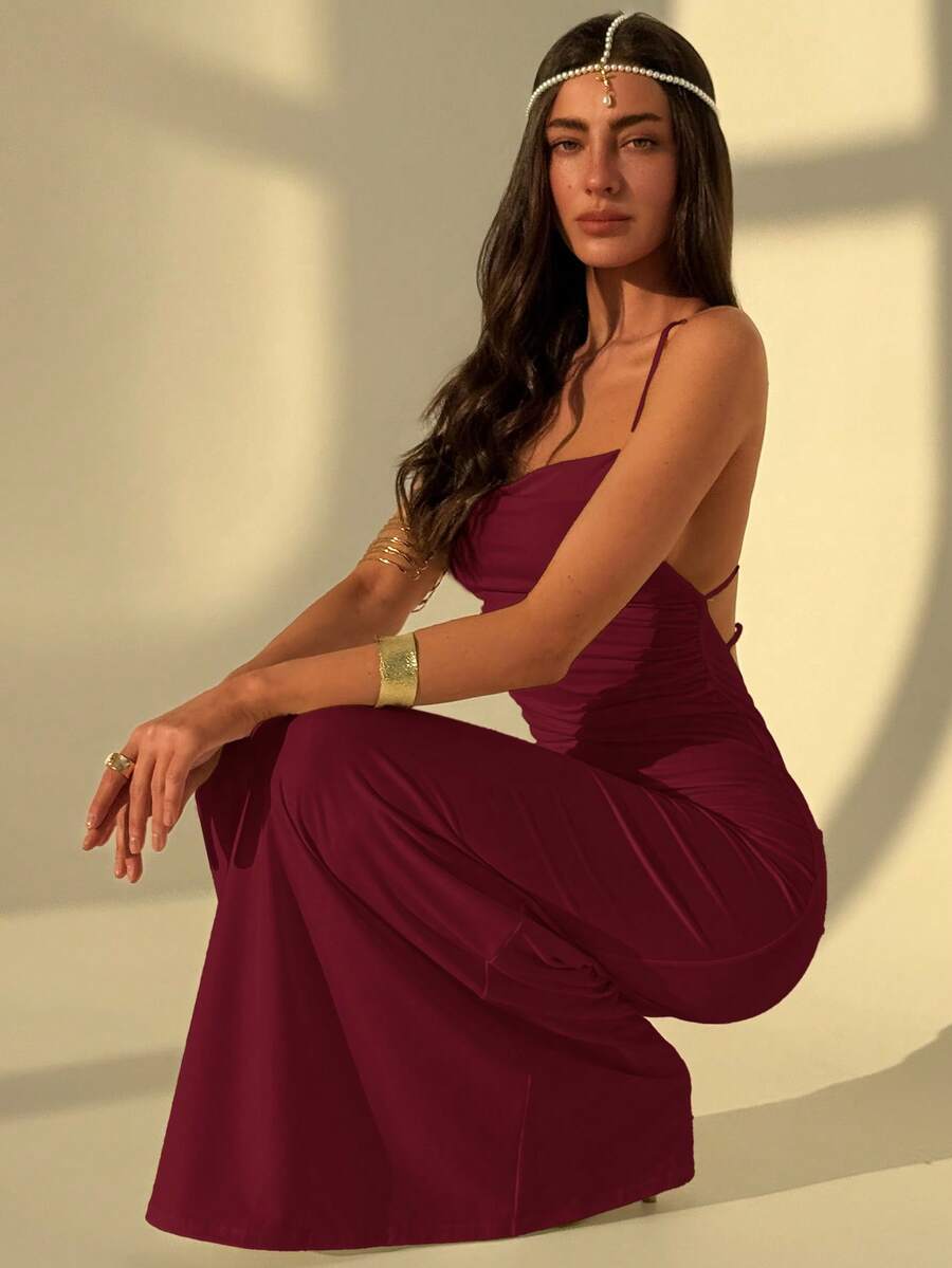 Slim fit backless halter maxi dress for women featuring criss-cross back details and spaghetti straps.
