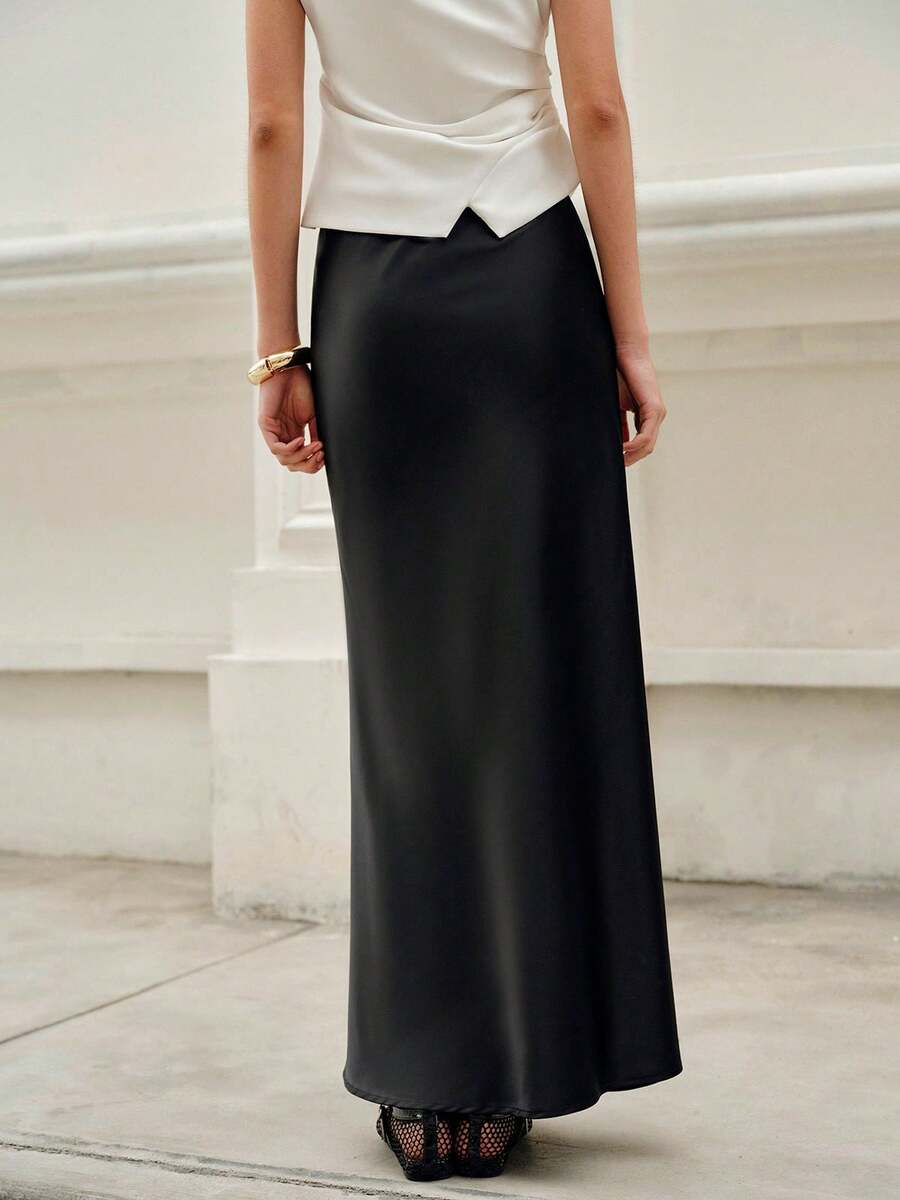 Elegant plain black mid waist long satin skirt for women featuring a sleek zipper closure and regular fit.