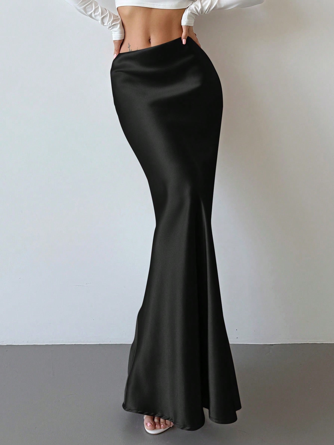 Elegant black satin high waist mermaid maxi skirt for women featuring a skinny fit and floor-length silhouette.