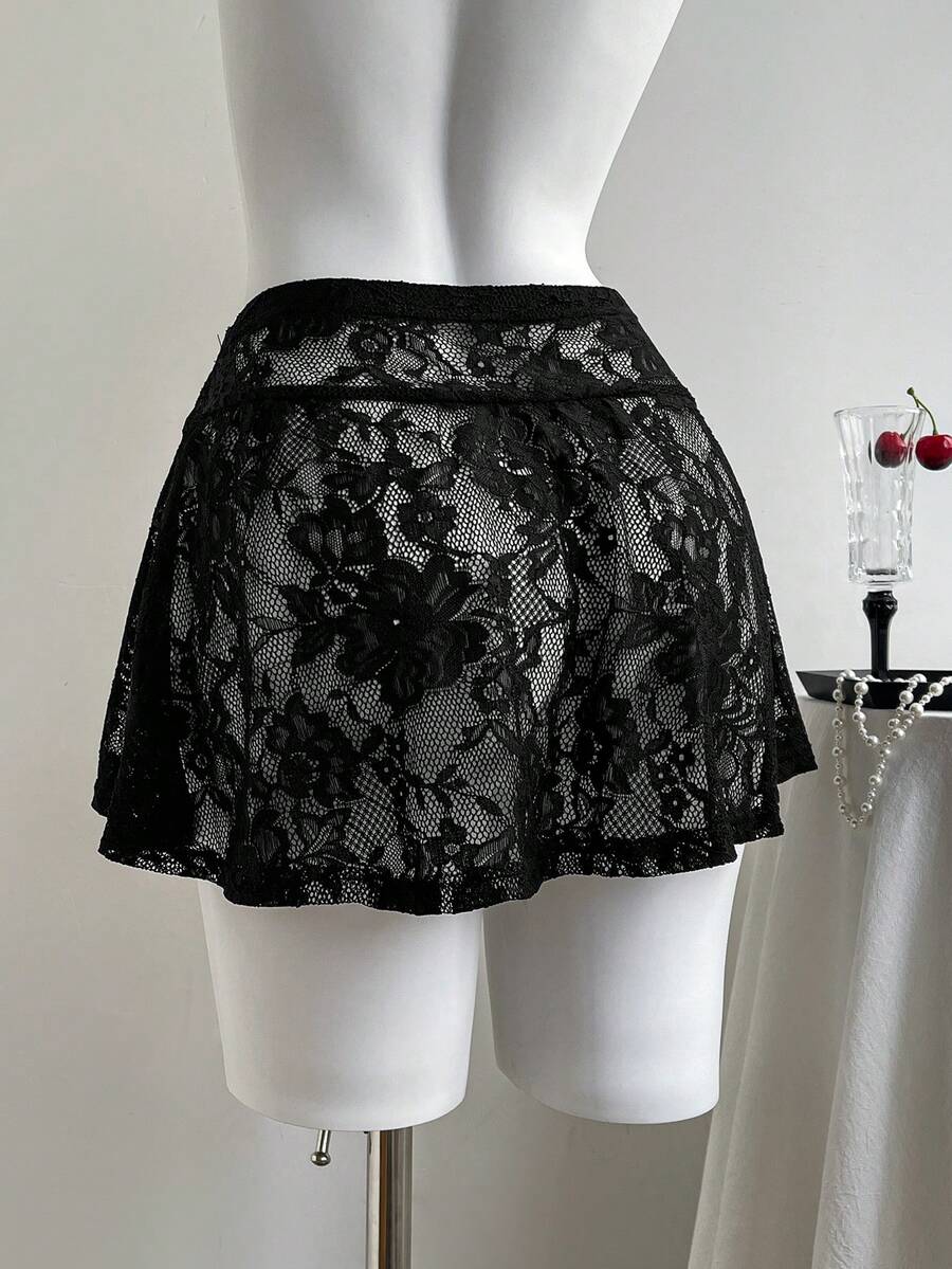 Women's black semi-sheer knitted lace mini skirt featuring a flared ruffle hem and low waist design