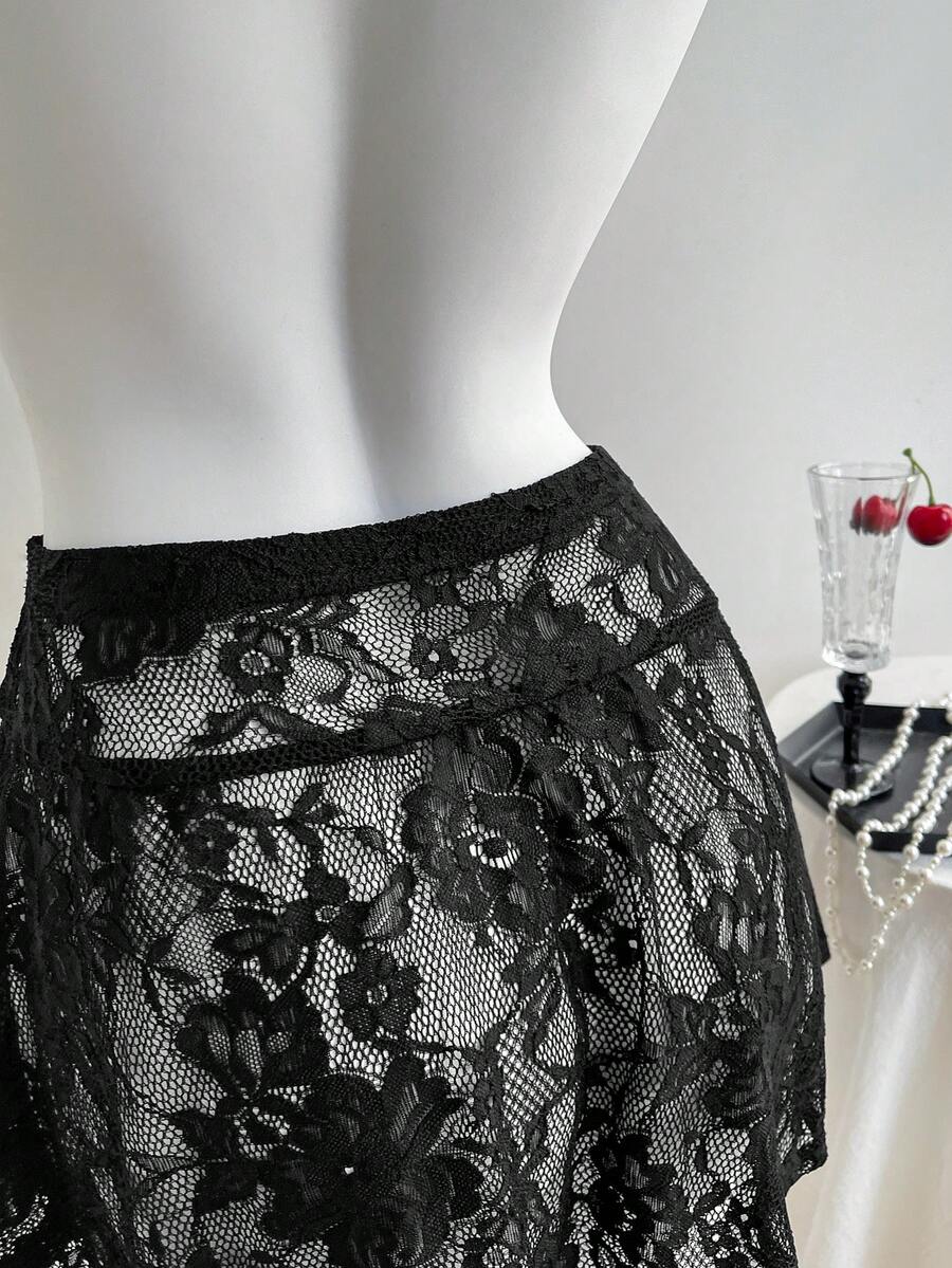 Women's black semi-sheer knitted lace mini skirt featuring a flared ruffle hem and low waist design
