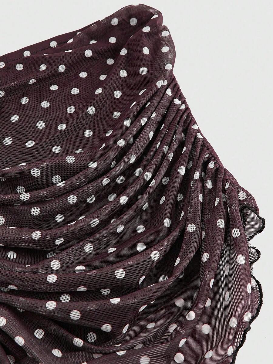 Women's black polka dot strapless tube top made of ruched mesh fabric featuring an asymmetrical hem and matching scarf.