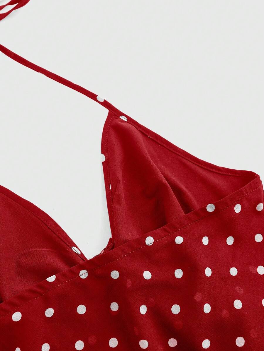 Black halter crop top featuring an asymmetrical ruffle hem and backless design for women.