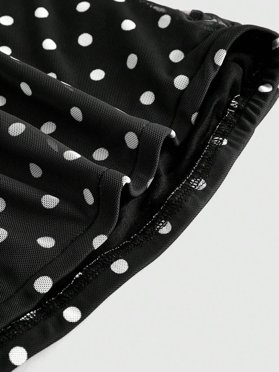 Women's black polka dot strapless tube top made of ruched mesh fabric featuring an asymmetrical hem and matching scarf.